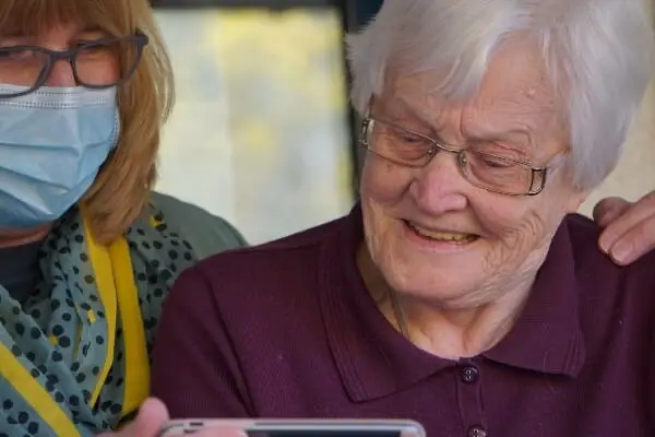 Care worker helping an elderly lady