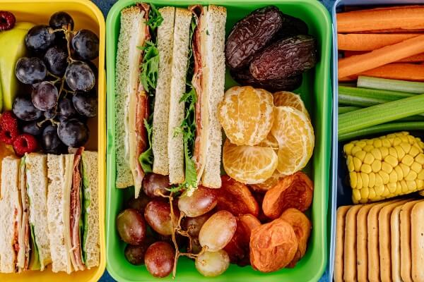Pack lunch with sandwiches and fruit