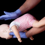 Doctor showing first aid for choking infant
