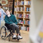 Cheerful,Positive,Handsome,Disabled,Student,With,Headphones,On,Neck,Sitting