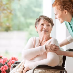 Young,Nurse,Helping,An,Elderly,Woman,In,A,Wheelchair.,Nursing