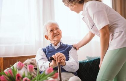 senior-man-with-walking-stick-being-comforted-by-nurse-hospice